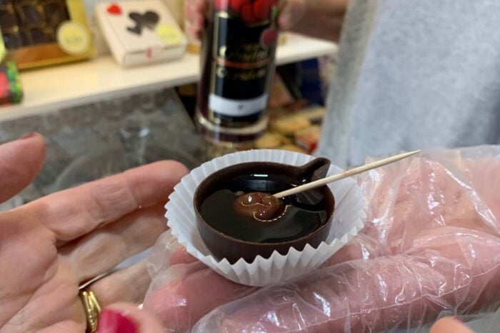 Ginjinha, Portuguese cherry liqueur, served in a small chocolate cup that you can eat.