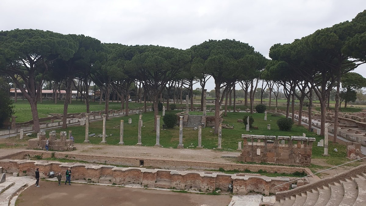 Ostia Antica: 11 lucruri de făcut în orașul de lângă Roma 2 Ruinele întinse ale Ostia Antica cu pini în formă de umbrelă într-o zi înnorată