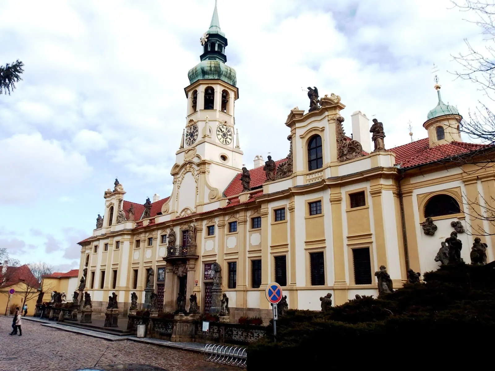 Baroque façade of the Prague Loreto in Hradčany with its clock tower