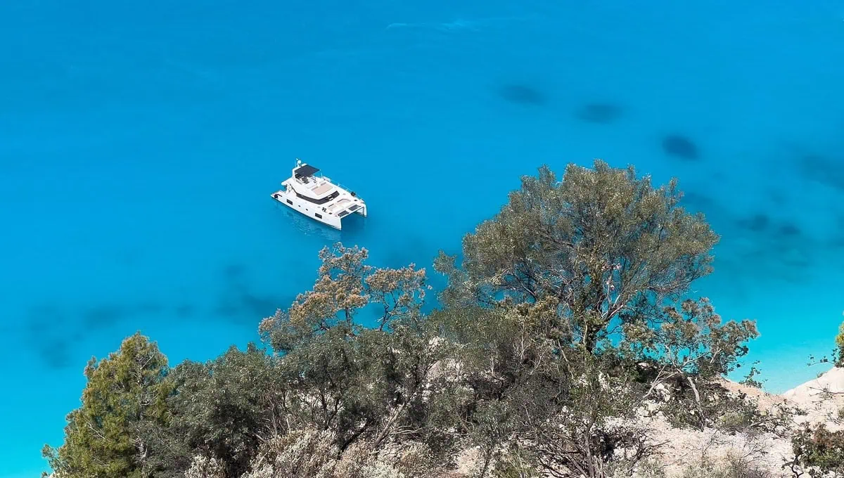 Egremni beach on Lefkada with a long white strip of sand beneath towering cliffs and turquoise sea