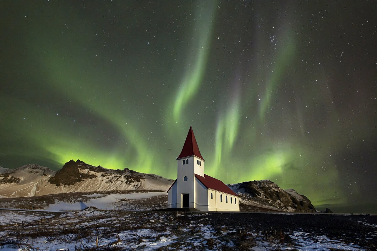 Aurora boreală: unde și când o vezi (12 cele mai bune locuri) 4 Aurora boreală deasupra unei bisericuțe din Islanda