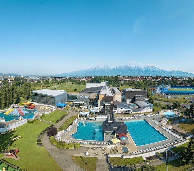 Best Aquaparks in Slovakia: 8 Spots to Visit with Kids in 2026 3 Aerial view of AquaCity Poprad resort with pools and the Tatras