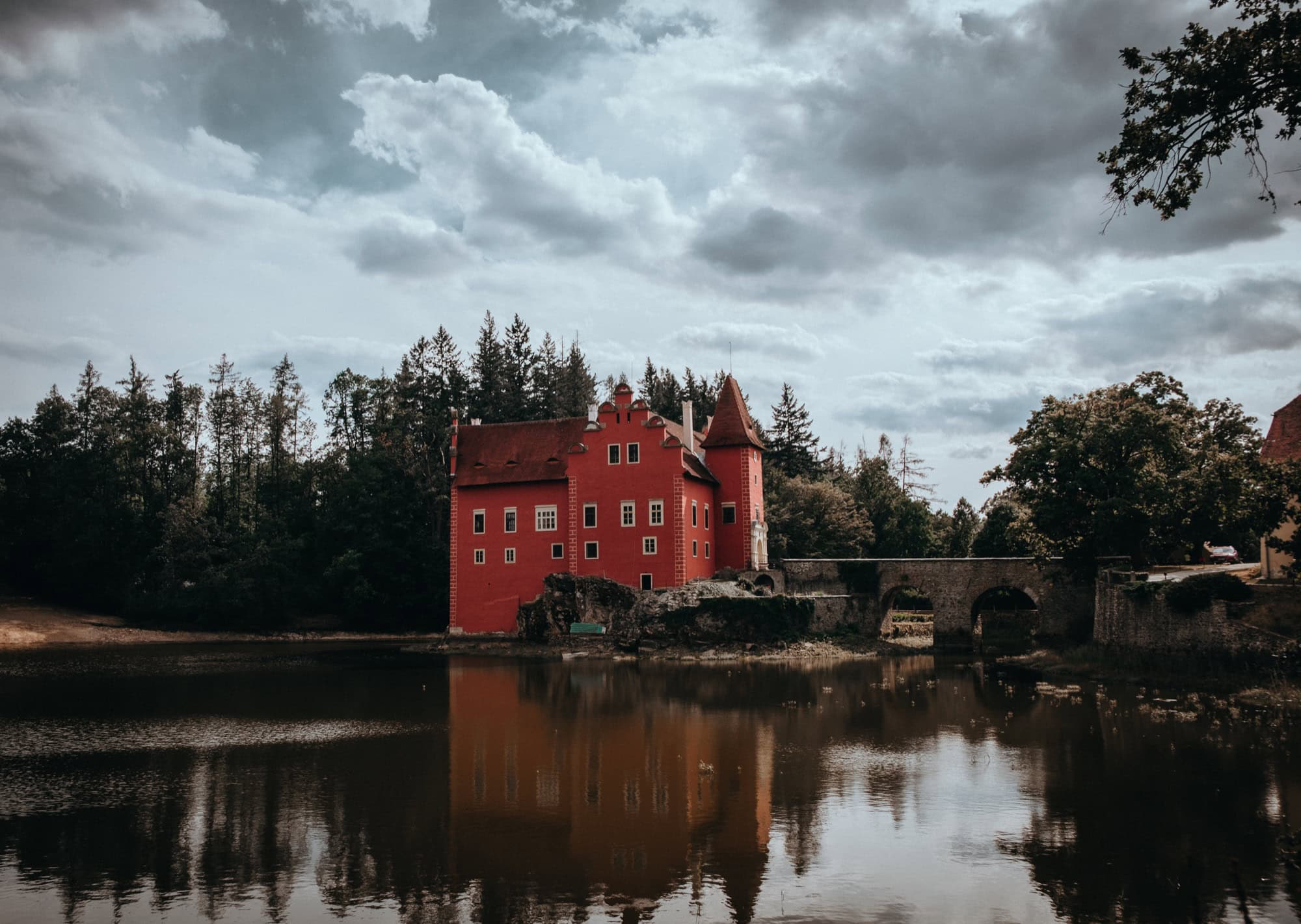 Červená Lhota Castle: 8 Tips on What to See & Know Before Visiting in 2026 84 Červená Lhota Castle reflected in the pond under a dramatic sky