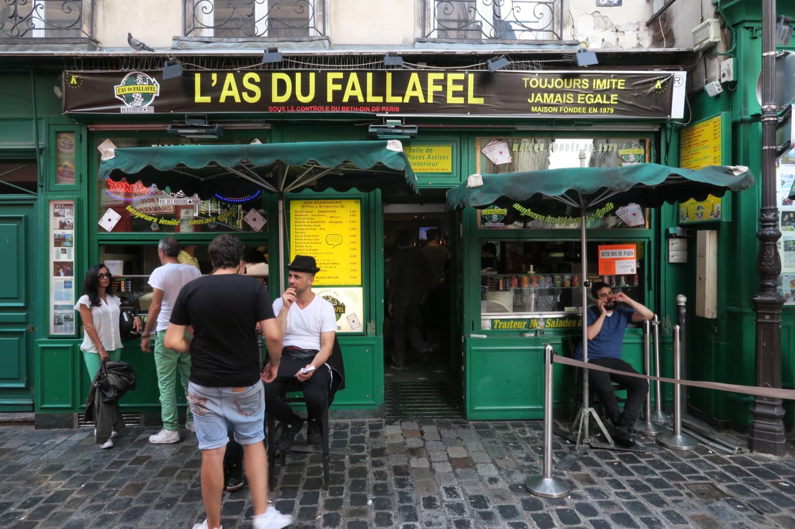 Ce să mănânci la Paris: Ghid foodie complet 2026 (bistrouri, Michelin, scena vegetariană) 27 Fațada verde a legendarului local de falafel L'As du Fallafel din Rue des Rosiers