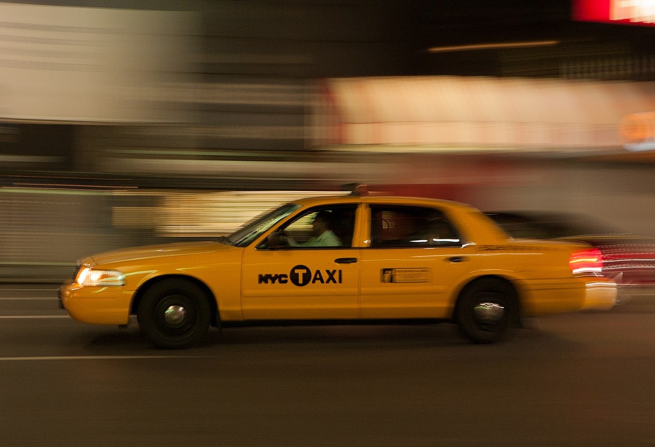 New York Transportation 2026: Subway (OMNY) and Getting From the Airport 47 A yellow New York taxi in motion