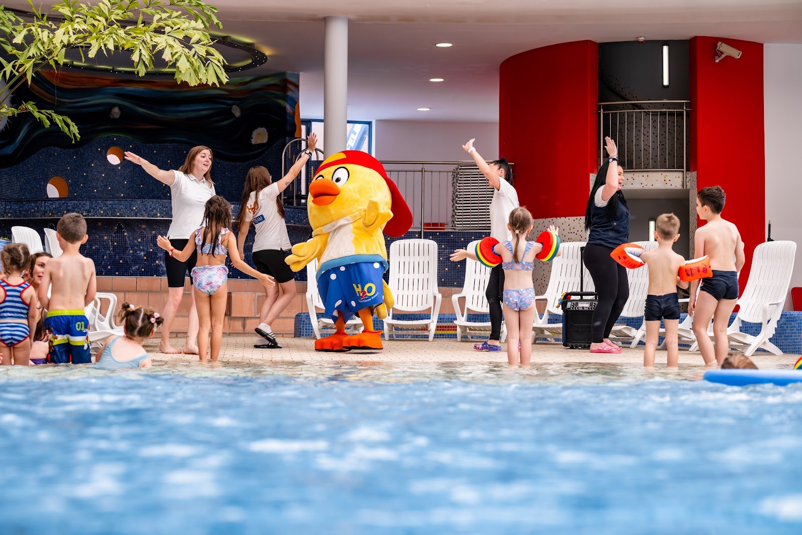 The Best Thermal Spas in Austria: 13 Spots to Visit in 2026 10 Children in the pool with the HopiHo mascot at H2O Therme Bad Waltersdorf