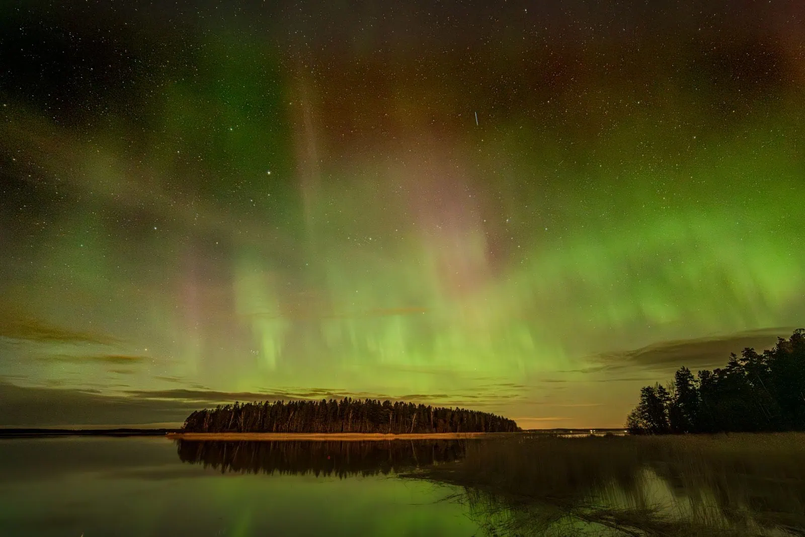 Northern Lights in Lapland: When, Where and How to See Them in 2026 3 Northern lights over a lake in Finnish Lapland