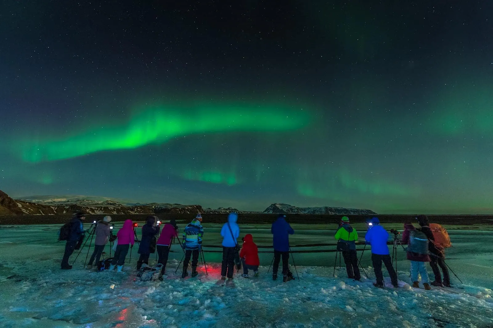 Northern Lights in Lapland: When, Where and How to See Them in 2026 4 People watching the northern lights on a tour