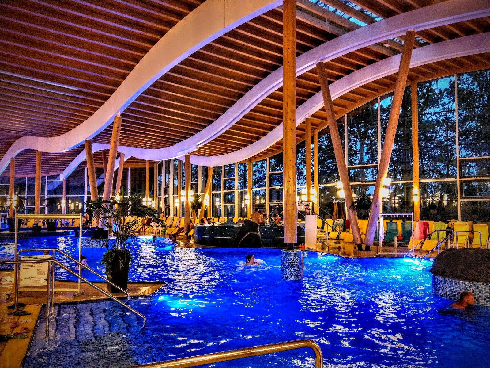 The Best Thermal Spas in Austria: 13 Spots to Visit in 2026 13 Indoor pool at Sole Felsen Welt in Gmünd with a wavy wooden ceiling