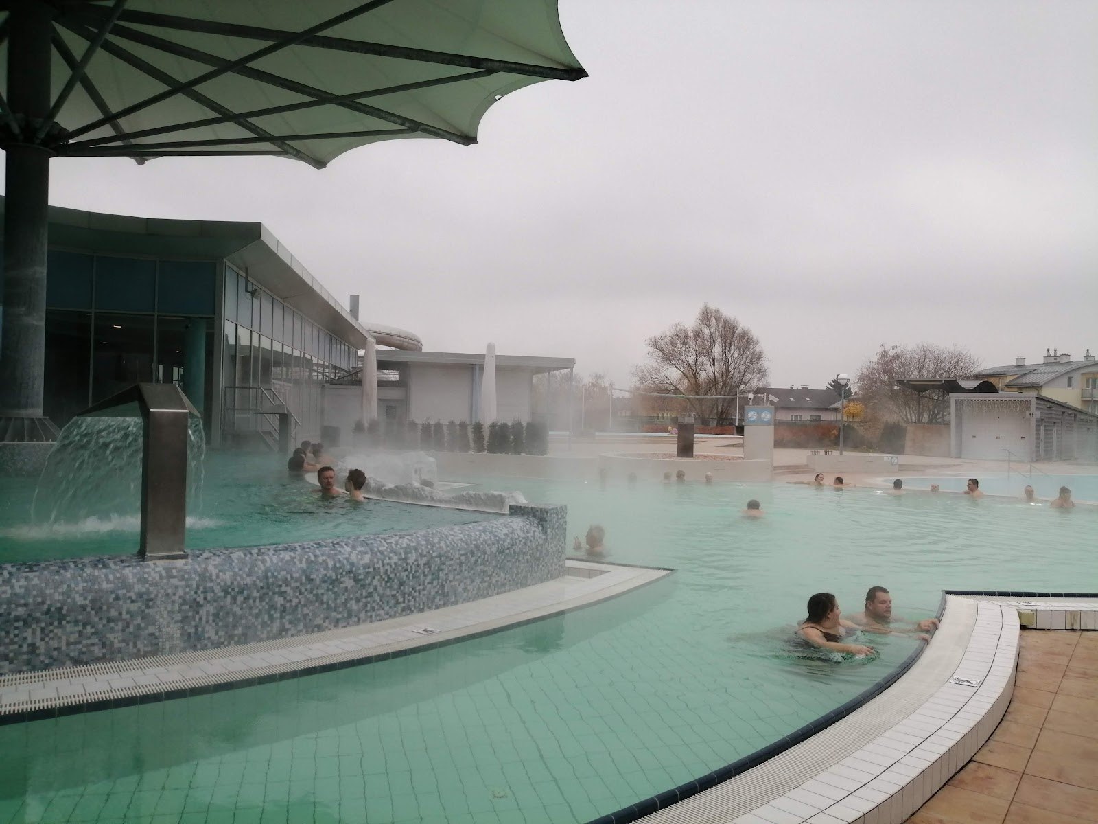 The Best Thermal Spas in Austria: 13 Spots to Visit in 2026 12 Outdoor thermal pool at Therme Laa shrouded in steam