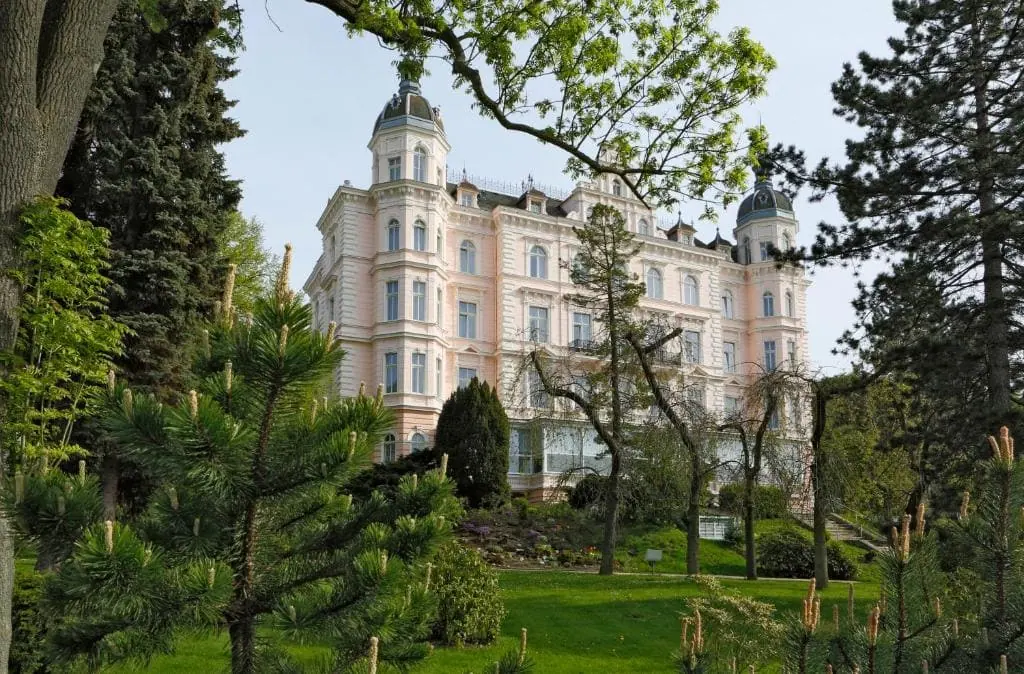 Pink facade of Hotel Bristol Palace in a park in the Westend district of Karlovy Vary