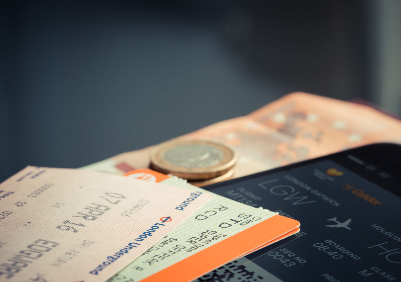 How Old Does a Baby Have to Be to Fly? Rules for 2026 5 A boarding pass, coins, and a phone showing flight details