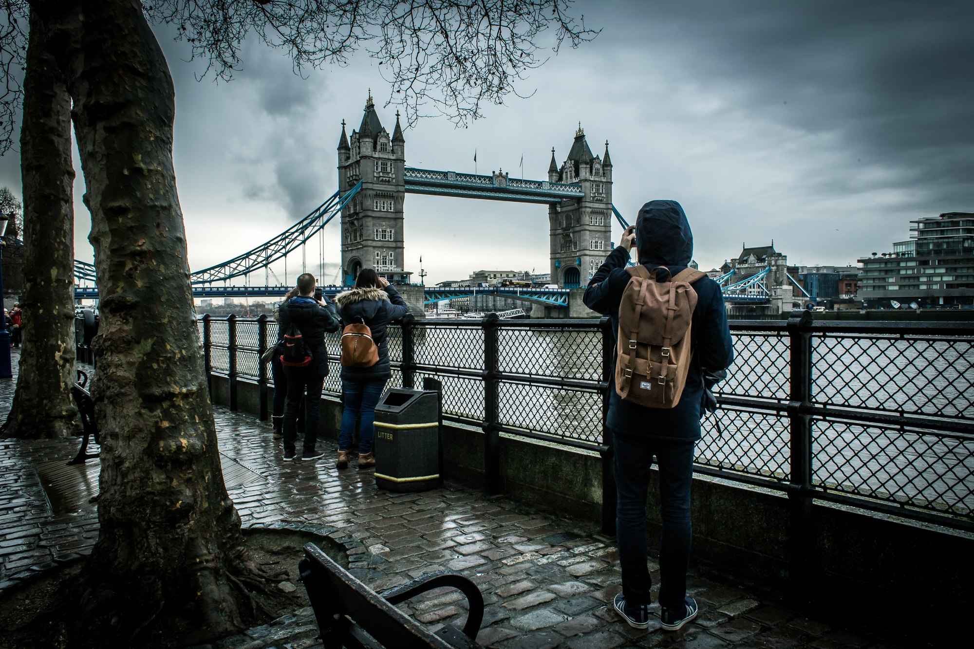 Tower Bridge din Londra, Anglia: bilete, podeaua de sticlă și când se ridică podul în 2026 7 Turist fotografiind Tower Bridge de pe malul Tamisei