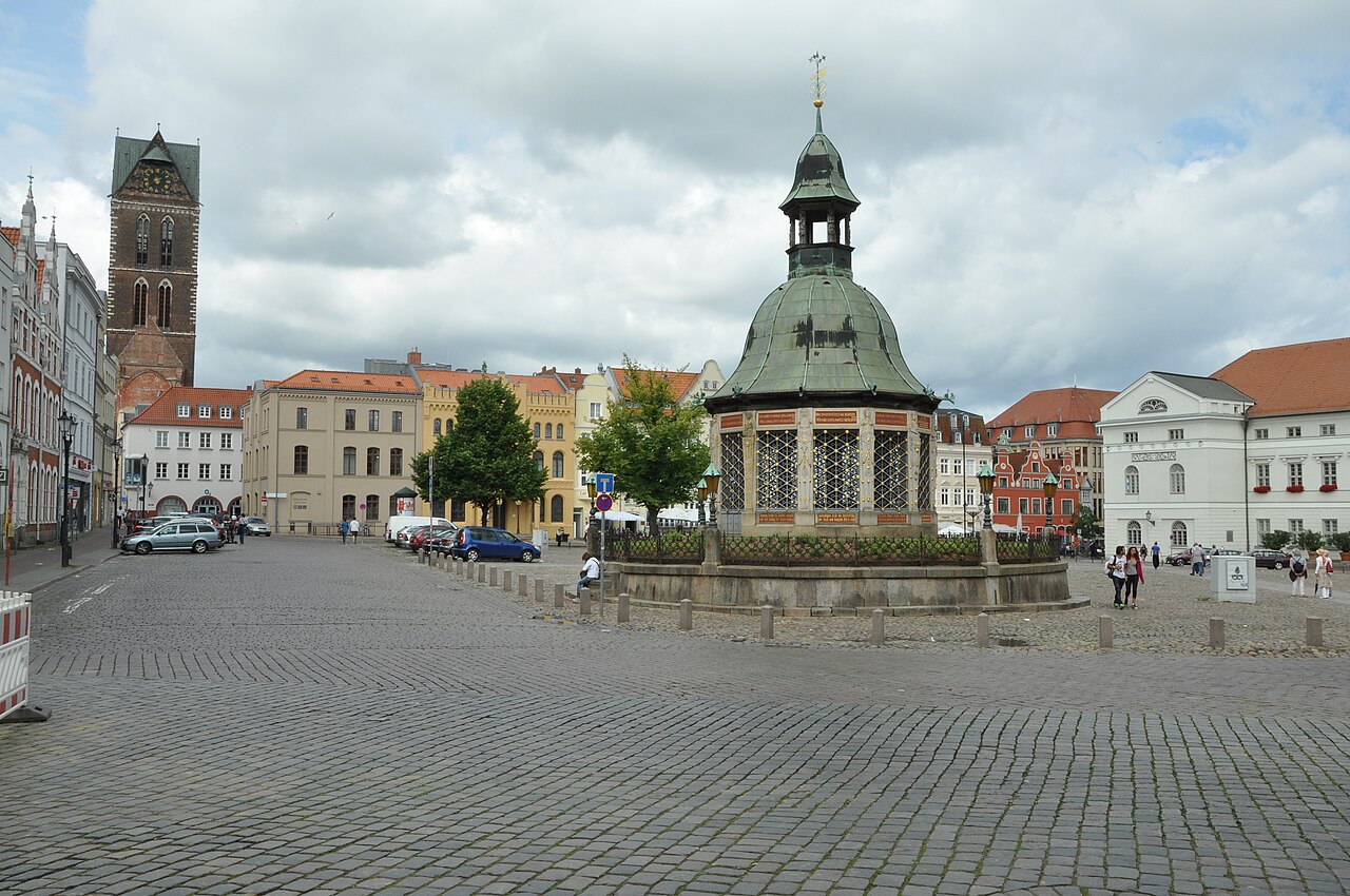 Rügen Island Germany: 12 Film Locations to Visit in 2026 18 Cobbled square in Wismar with the tower of St Mary's Church
