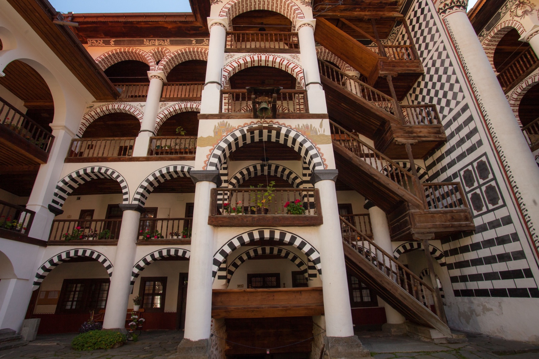 Holiday in Bulgaria 2026: 30 Most Beautiful Places + Practical Tips 20 Striped arcades in the courtyard of Rila Monastery