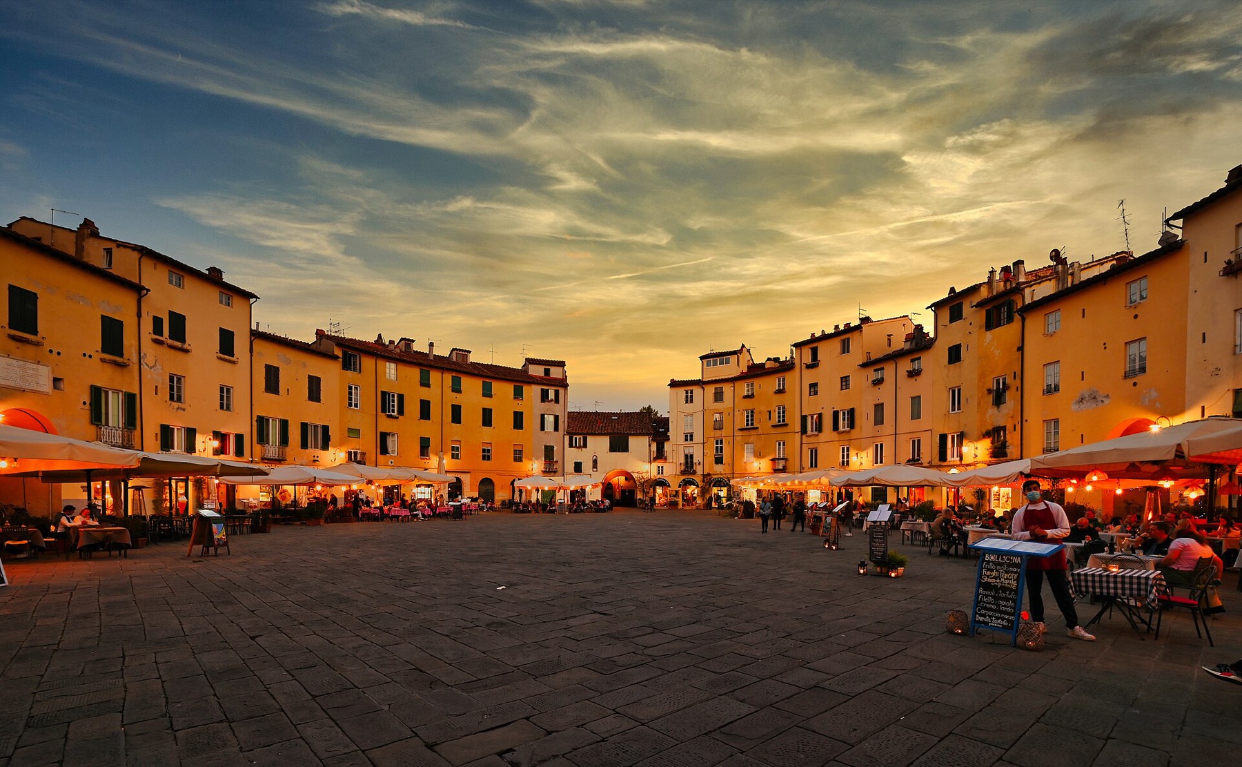 Lucca, Itálie: 22 tipů, co vidět a proč objet hradby na kole 10 Oválné náměstí Piazza dell'Anfiteatro v Lucce při západu slunce