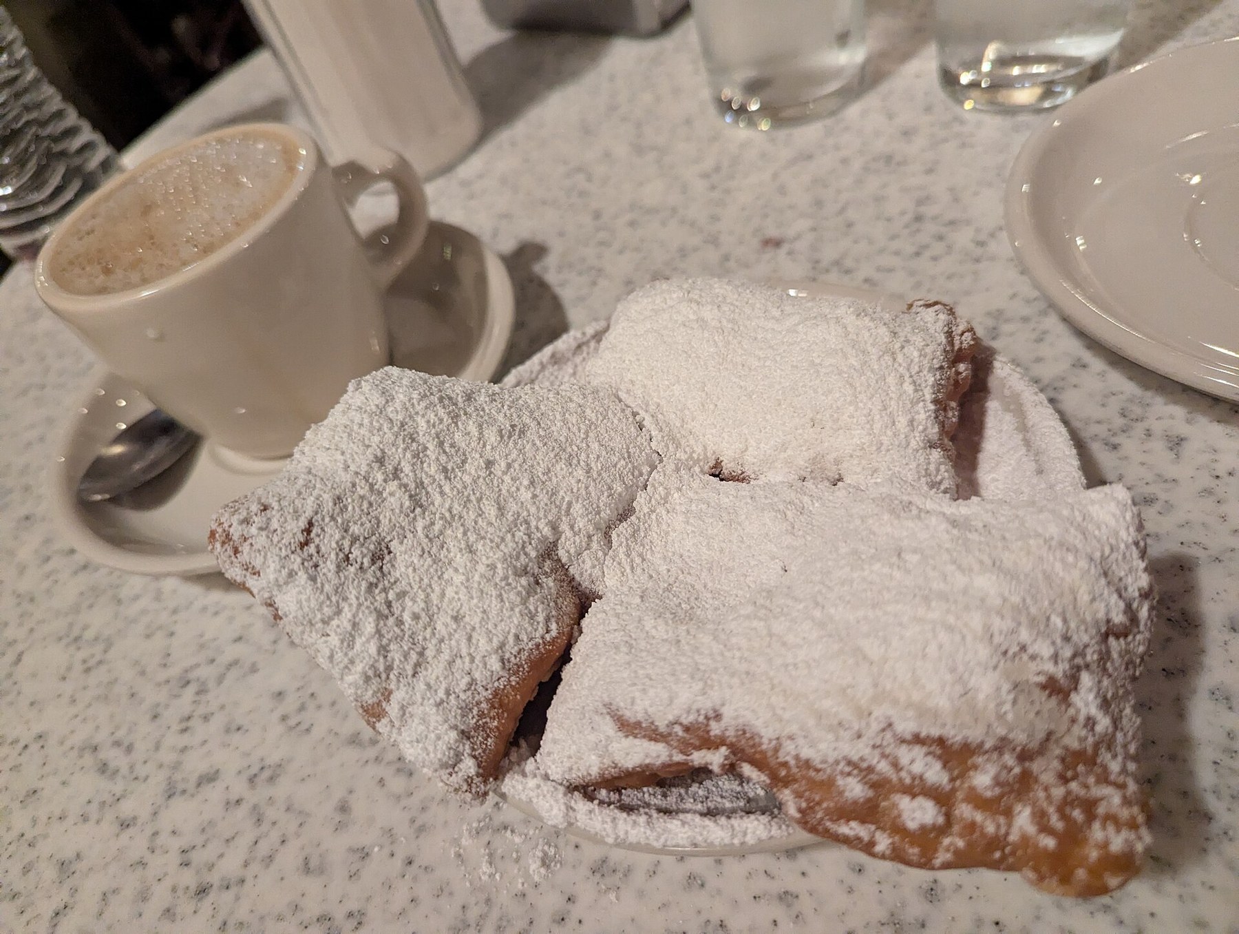 Things to Do in New Orleans: 18 Must-See Spots 4 Powdered-sugar beignets and coffee at Café du Monde