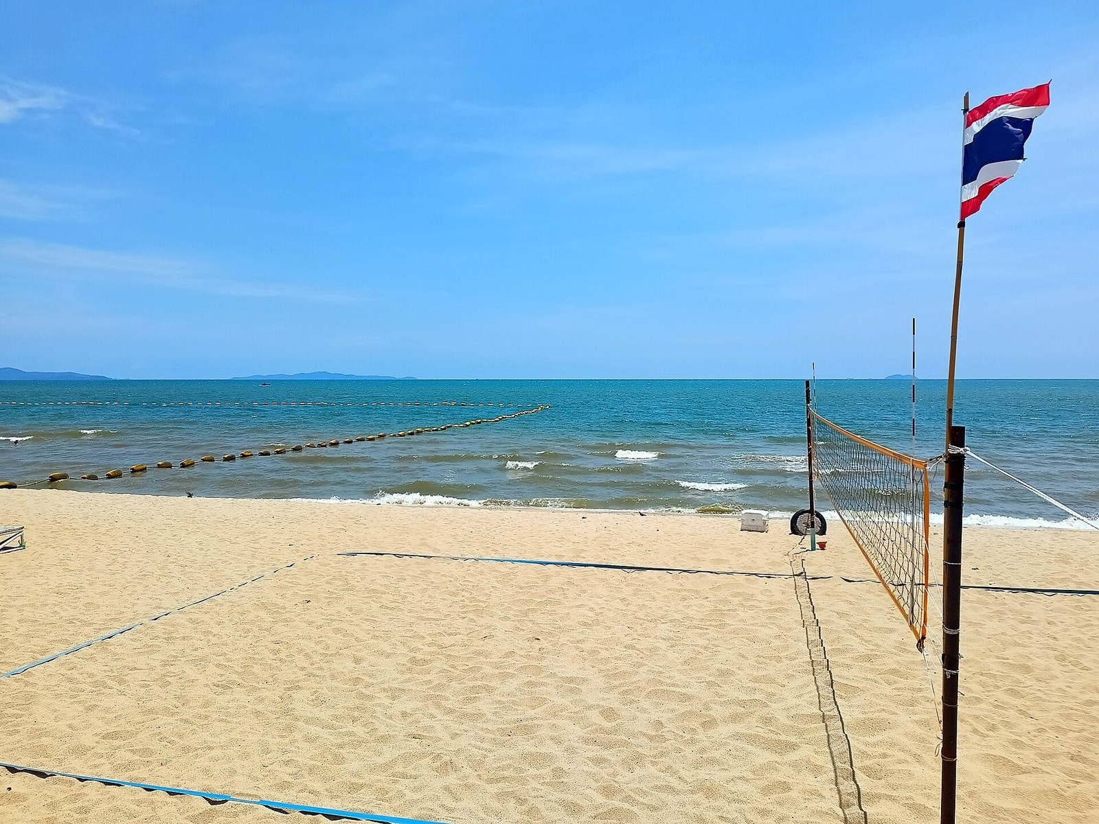 Pattaya, Thailand: 15 Things to See and Do in 2026 7 Sandy Dongtan Beach with trees and Thai flag